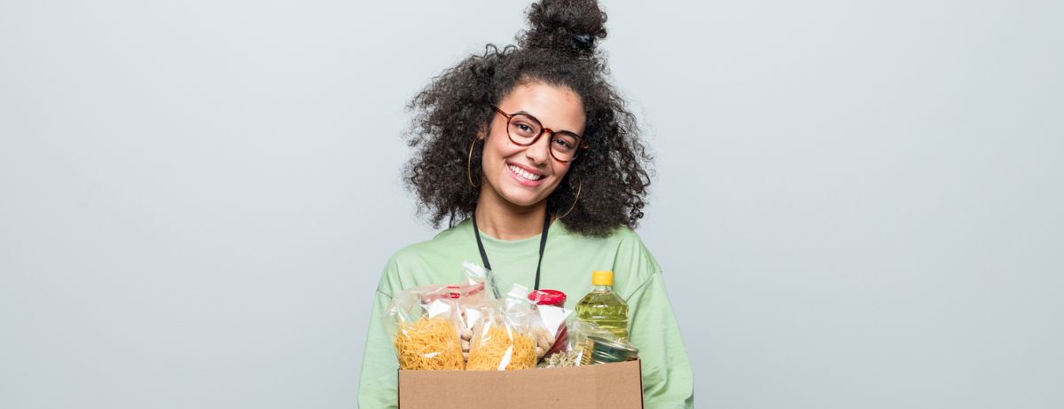 woman carrying box of food